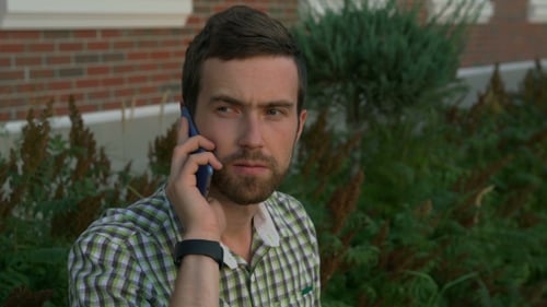 Man Talking on Cell Phone Outdoors