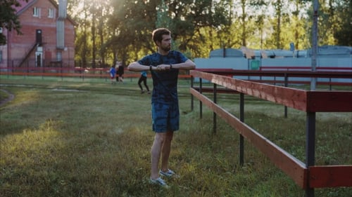 Man Warming Up on Lawn on a Sunny Day