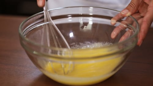 Whisking Eggs in Glass Bowl with Sugar