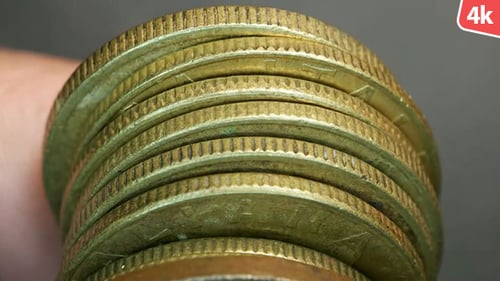 Close-Up of Stacked Bronze-Colored Currency Coins