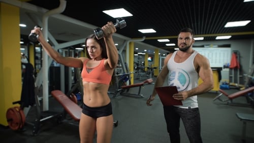 Fitness Instructor And Client At The Gym.