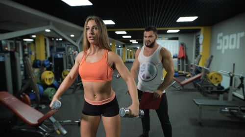Young Girl Exercises With Personal Instructor