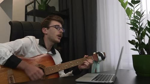 Man Plays Acoustic Guitar Indoors