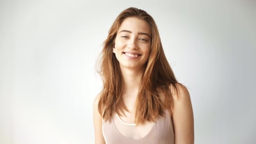 Happy Young Woman Smiling in Studio