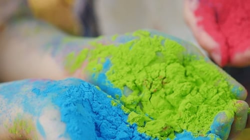 Hands Holding Bright Powders for Holi Celebration