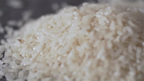 Dropping Rice On Craft Black Background