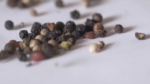 Black Peppers Drop On White Background