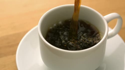 Coffee Pouring into White Mug, Close Up