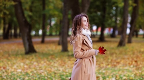 Beautiful Young Woman Walking In Autumn Park 1