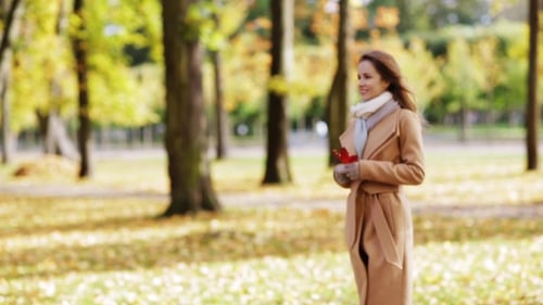 Beautiful Young Woman Walking In Autumn Park 2