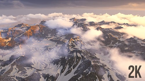 Epic Aerial View of Snow Capped Mountains with Moving Clouds