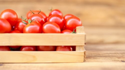 Fresh Cherry Tomatoes in Wooden Crate on Table