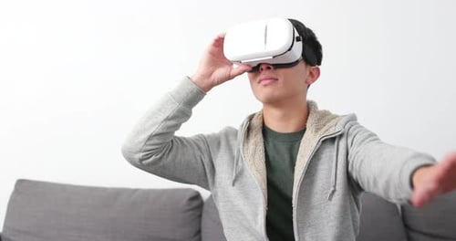 Young Adult Using Virtual Reality Headset at Home