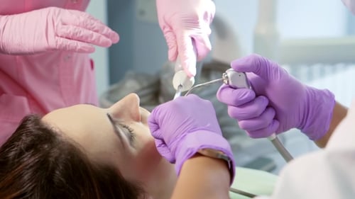 Dentist Performing Dental Procedure On Patient