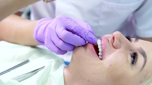 Dentist Working on Patient's Teeth with Gloves