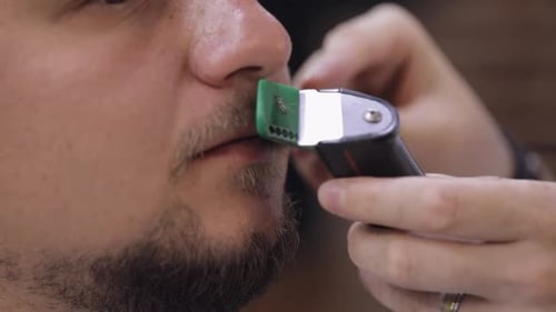 Barber Cutting Beard Using Electric Trimmer Makes Haircut for Groom Man Customer at Barber Shop