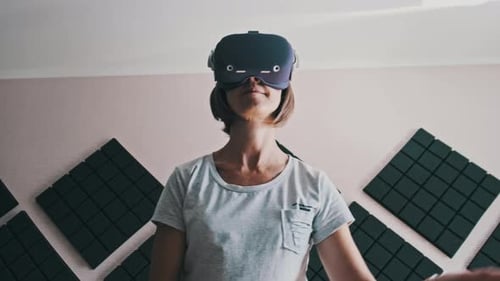 Woman Wearing VR Headset Using Controllers Indoors