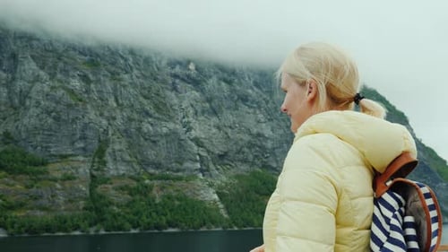 Woman Feeding Seagulls on Boat Tour in Fjord