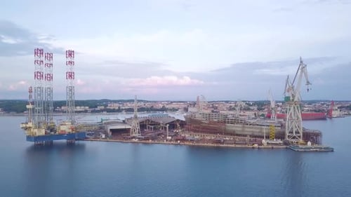 Aerial View of Shipyard, Cranes, and Oil Rig