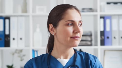 Professional medical doctor working in hospital office. Young and attractive female physician.