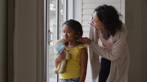Mother and Child Look Out Window with Teddy Bear