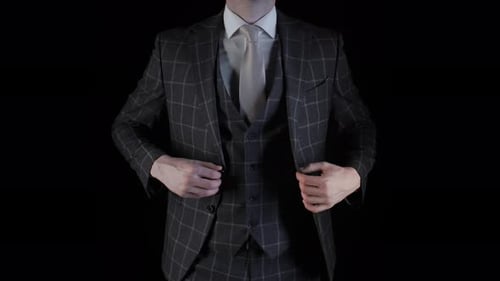 Handsome Businessman Button His Suit Jacket Getting Ready Isolated on Black Background