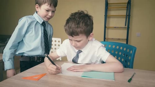 Two Boys Doing Homework Together Inside
