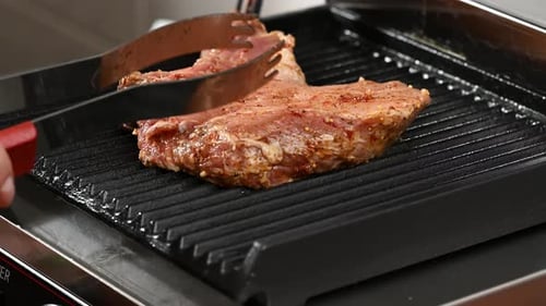 Fried piece of pork meat on the bone on the grill, barbecue