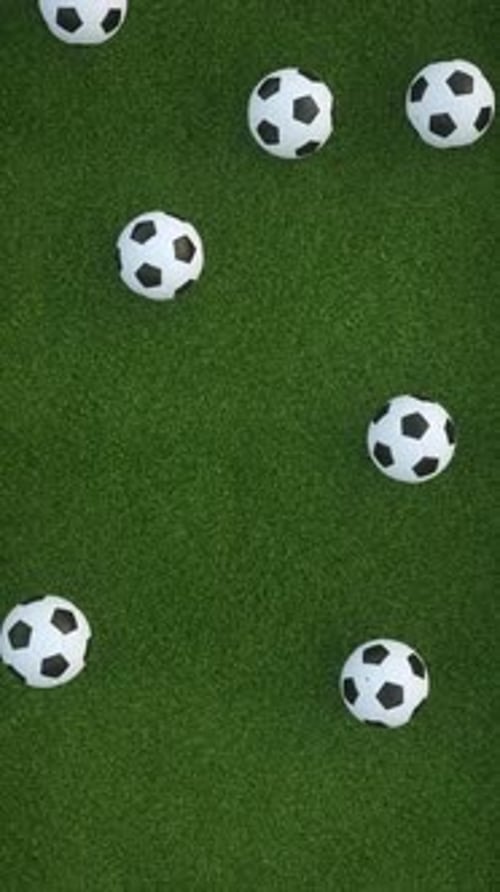 4K video animation. Soccer balls falling on grass field. Sports concept.