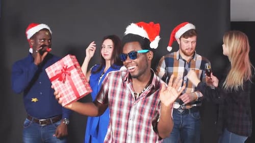 Enthusiastic Group Celebrates Christmas Indoors With Friends
