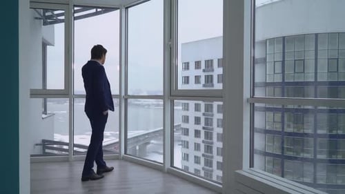 Man in Suit Talking on Cell Phone Indoors