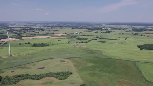Aerial view of windmills farm for energy production on beautiful cloudy sky at highland. Wind power