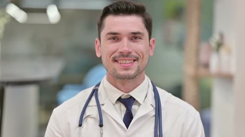Friendly Doctor Smiles at the Camera