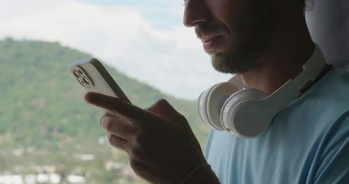Cropped View of a Handsome Guy Standing By Window Overlooking Beautiful Landscape with Mountains and