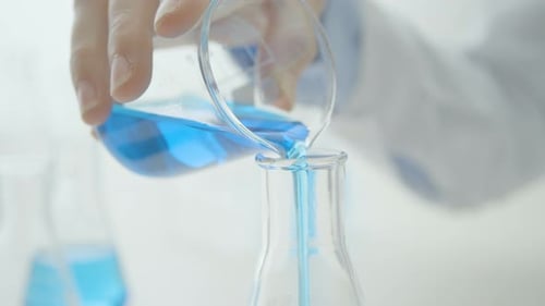 Close Up of Glass Beaker Being Poured