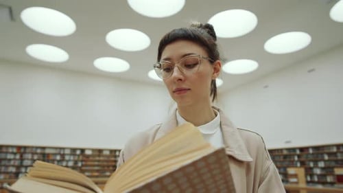 Beautiful Woman Reading Book in Library