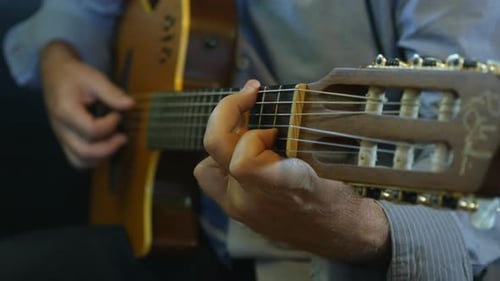 Man Playing Acoustic Guitar Close Up