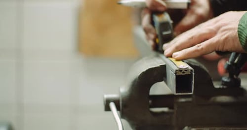 Man Working at Metal Industry - Cutting and Measuring Metal Parts at Workshop
