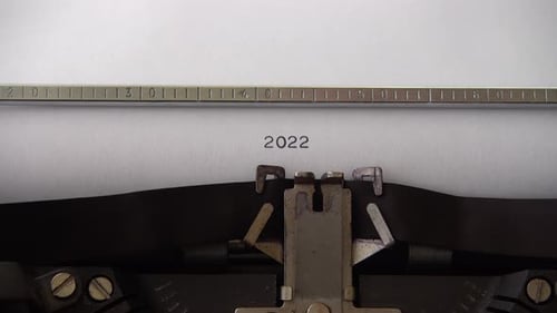 Typing 2022 on retro typewriter. Close up.