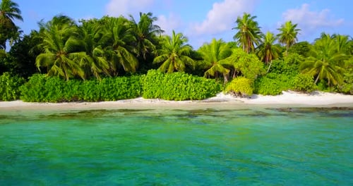 Beautiful birds eye tourism shot of a white sandy paradise beach and blue ocean background in vibran