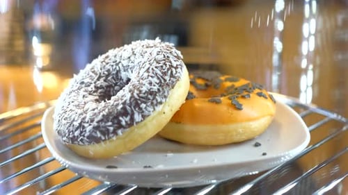 Appetizing donuts rotation on showcase in a coffee shop.