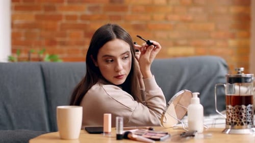 Young Woman Applying Mascara at Home