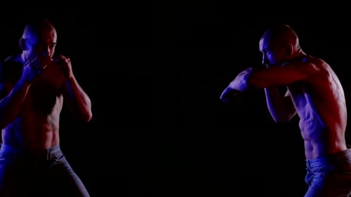 Shirtless Men Boxing in Dramatic Lighting