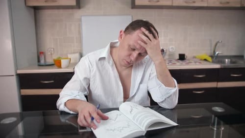 A businessman is reading a book with graphs