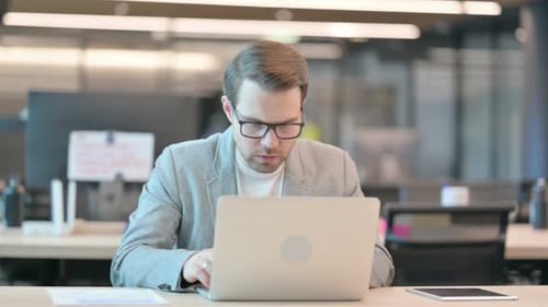 Frustrated Adult Using Laptop in Modern Office