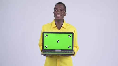 Young Adult Holding Laptop with Green Screen