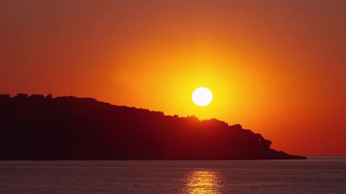 Sunrise over the Ocean with Dark Island
