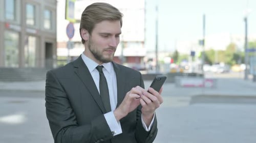 Young Adult Using Phone in the City