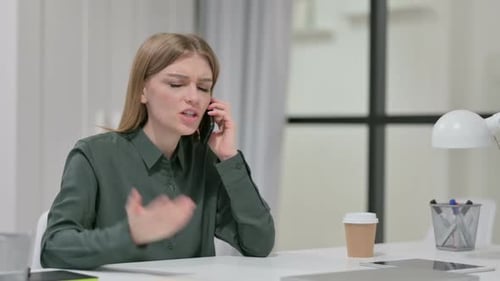 Furious Woman Yelling on Phone at Desk