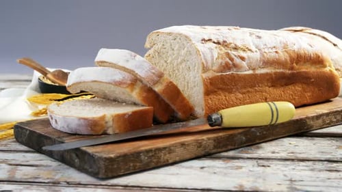 Fresh Crusty Bread Sliced on Cutting Board